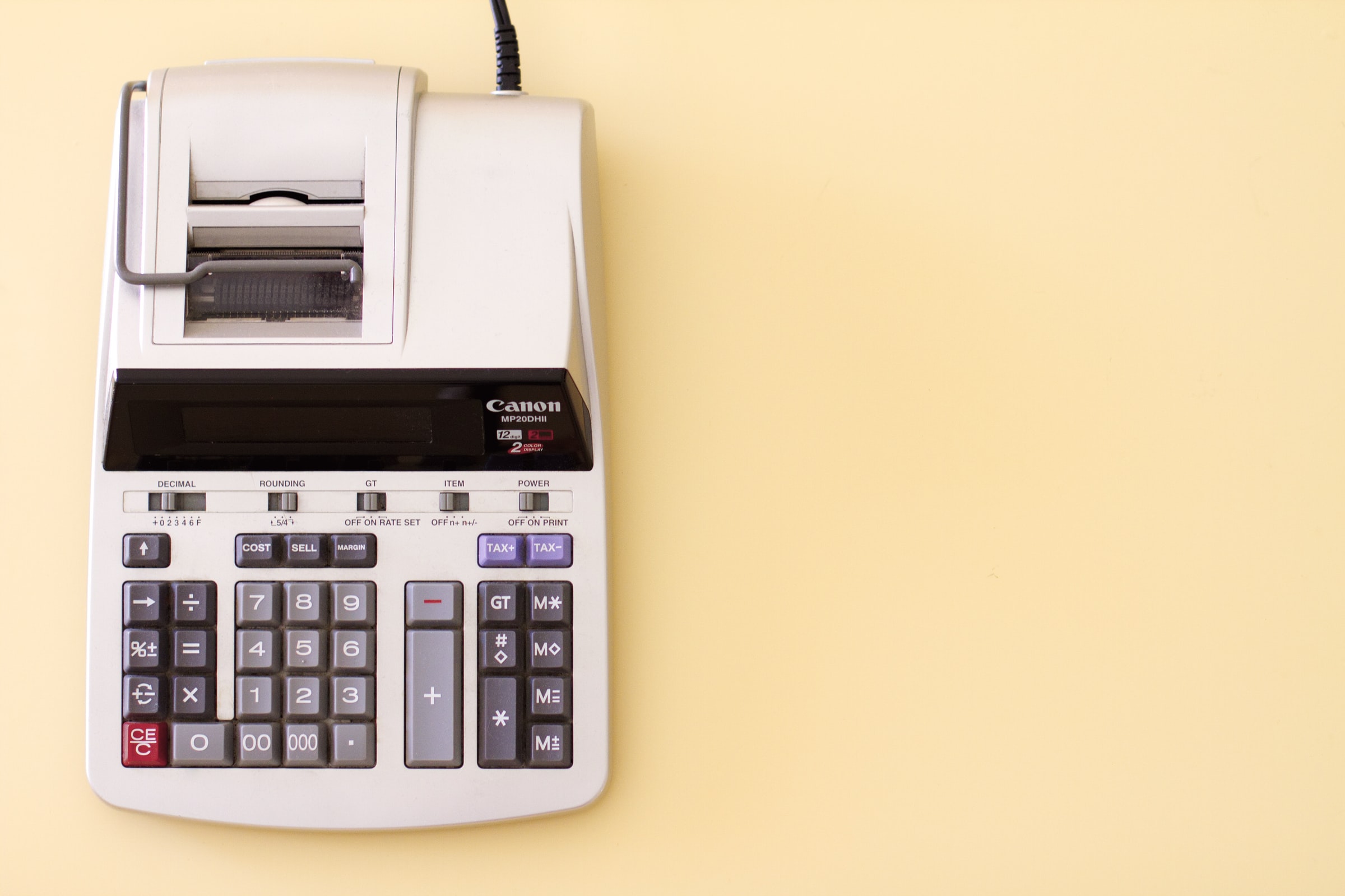 None Ten key accounting calculator on yellow desk.